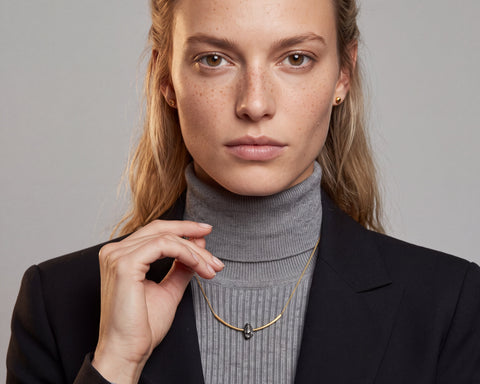 Crescent necklace worn on the neck, raw grey diamond set into a brushed 14K yellow gold arc, by LAYANI Fine Jewelry Jerusalem