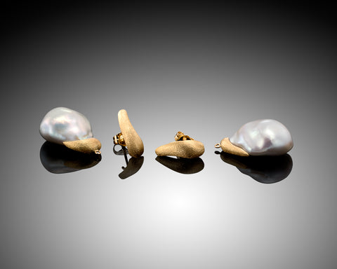Gold studs shown separated from their Keshi pearl drops, laid flat