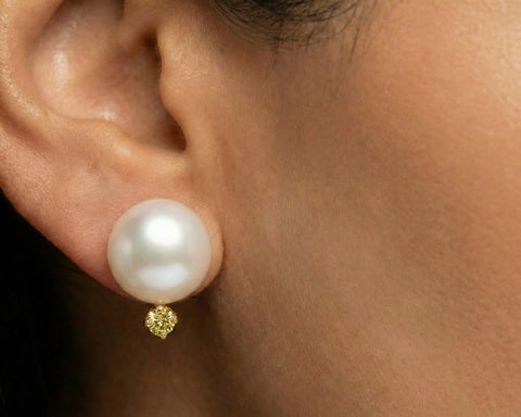 Yellow Dot pearl stud earring worn on the ear