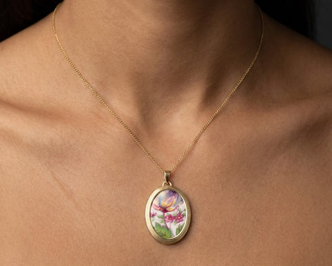 14K yellow gold engagement plate pendant on model, close-up of hand-painted ceramic fragment