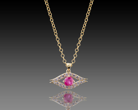 Gold evil eye pendant with pavé diamonds and a ruby at the center