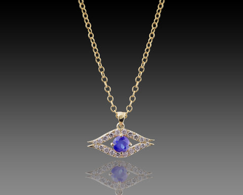 Yellow gold guardian eye pendant with a blue sapphire center stone