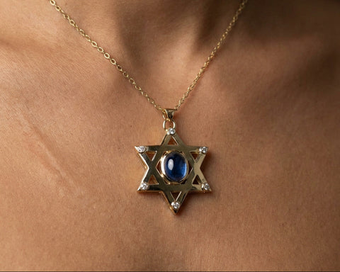 Star of David pendant with star sapphire worn at the neckline