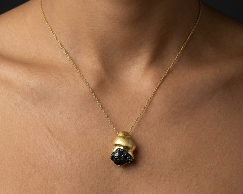 Gravity raw black diamond pendant in 14K yellow gold worn on a 42 cm chain