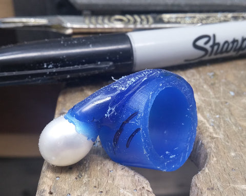 Blue wax carving of the open ring with the pearl placed in position