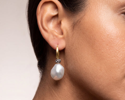 Luna hook earring worn on the ear, keshi baroque pearl and raw grey diamond in 18K yellow gold