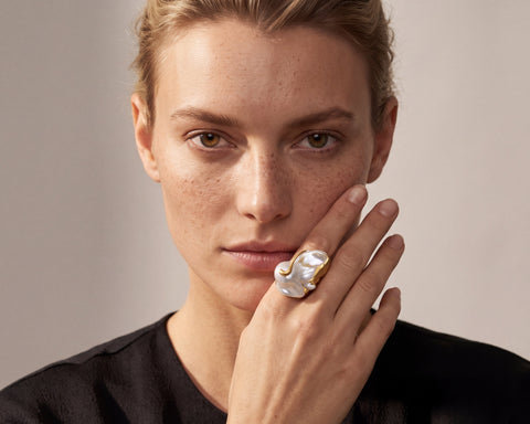 A model wearing the Mantle ring, a large Baroque Keshi pearl ring in 18K yellow gold