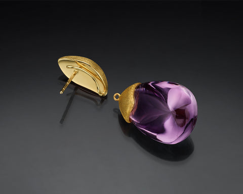 Gold stud shown separated from its amethyst drop, with the back post visible