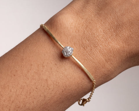 Tarvos raw diamond bracelet worn on the wrist, 18K yellow gold rolo chain