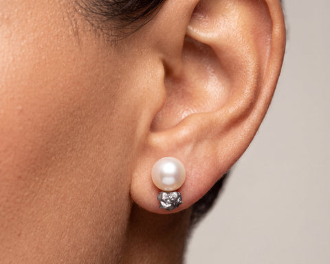 Venus stud earring worn on the ear, freshwater pearl and raw grey diamond in 18K yellow gold