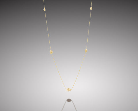 Anemone long necklace in yellow gold, seven brushed hollow nuggets with diamonds spaced along a fine chain