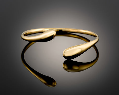 Open sculpted bangle in gold plated silver, thickening through the curves