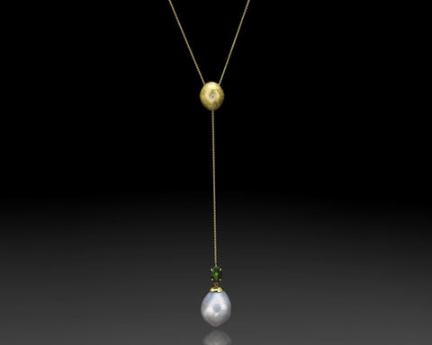 Green Flame lariat necklace in yellow gold, a hollow brushed nugget with a diamond, and a green tourmaline and white keshi pearl at the end of the chain