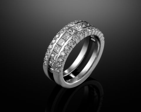 Wide ring in 18K white gold, a channel of princess diamonds between two pave-set rails