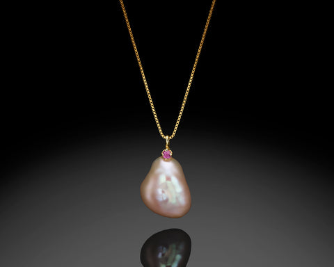 Lighthouse pendant in yellow gold, a purple keshi pearl with a small ruby set in gold