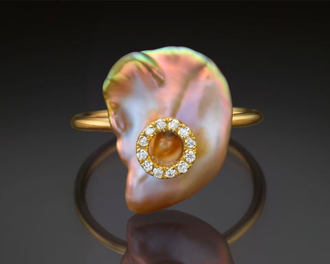 Nikea ring in yellow gold, a large white keshi pearl in an open band with a diamond pave collar