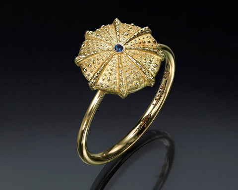 Sea urchin ring in 14K yellow gold with a blue sapphire at the center of the hollow dome