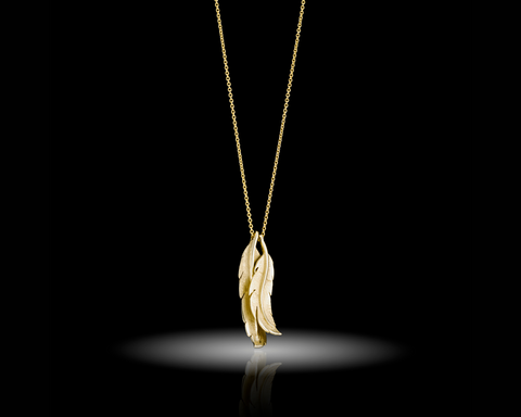 Two hand engraved gold feathers hanging on a fine chain